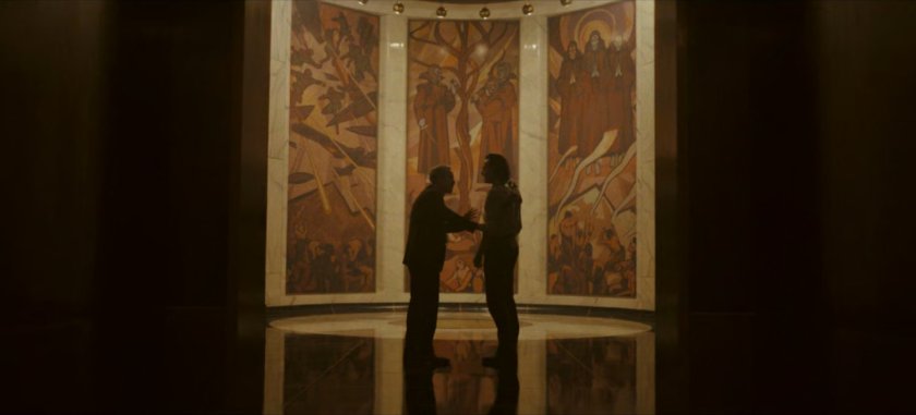 Mobius and Loki in TVA Hallway by a mosaic outside the War Room.