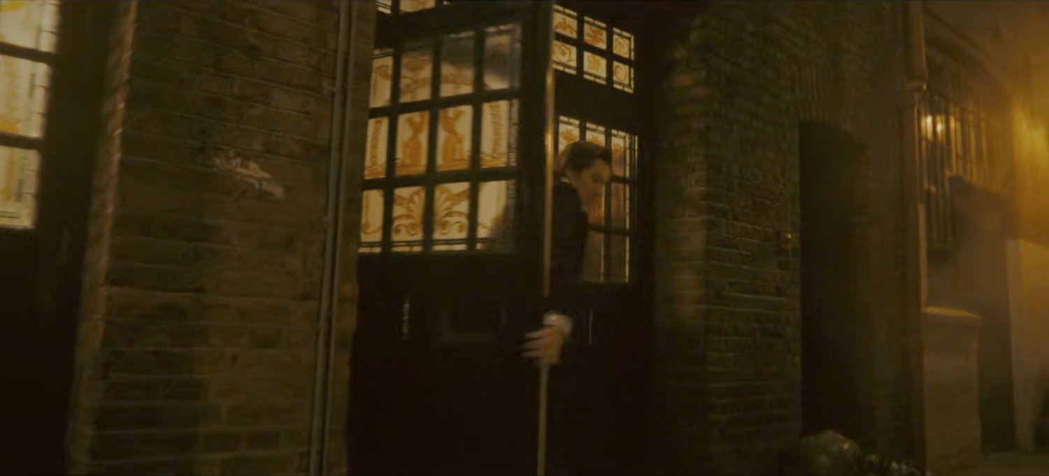 Brad exits the theater into a dark alley.