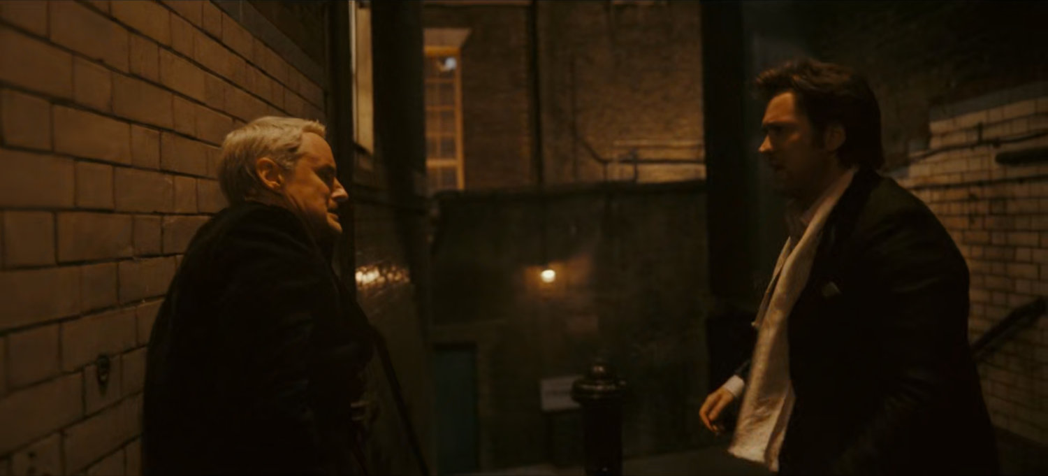 Mobius and Brad in a dark London alley.