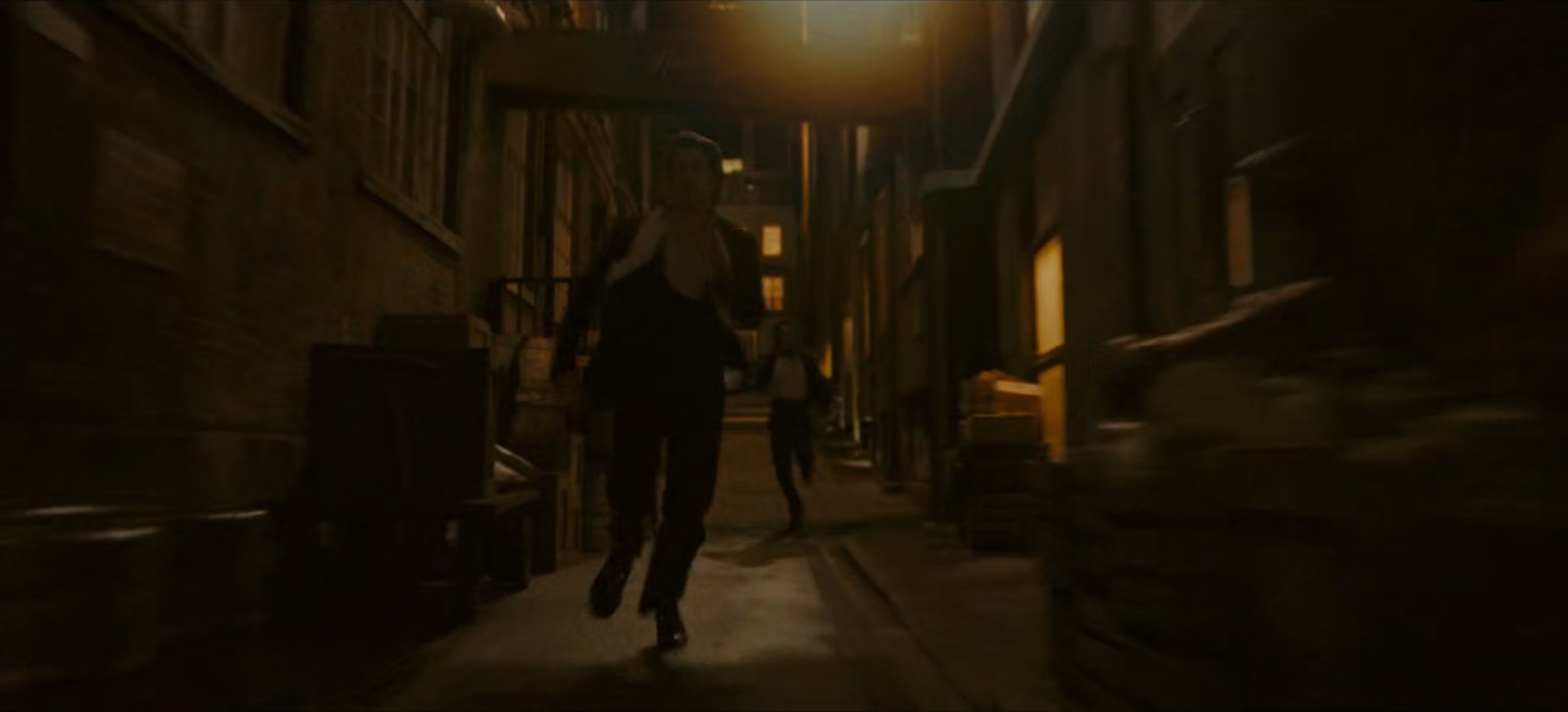 Loki chases Brad through dark alley.