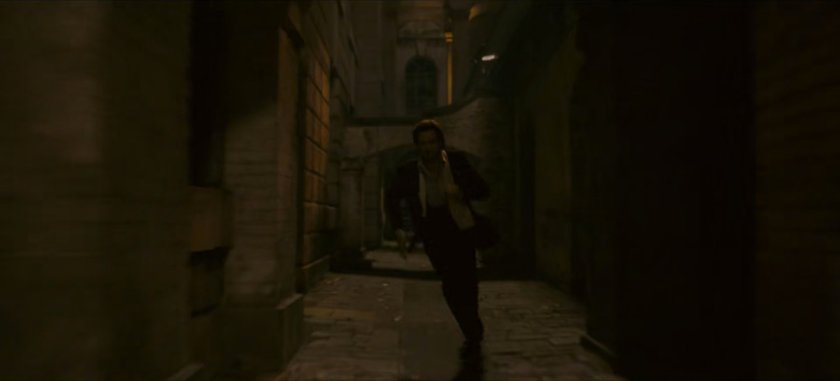 Loki chases Brad through dark alley.