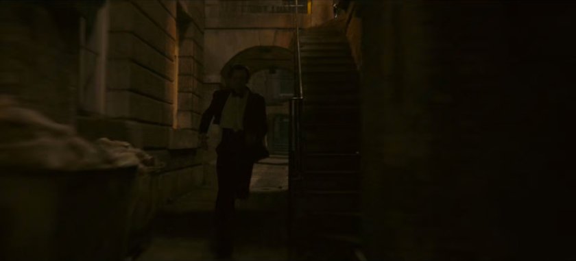 Loki chases Brad through dark alley.