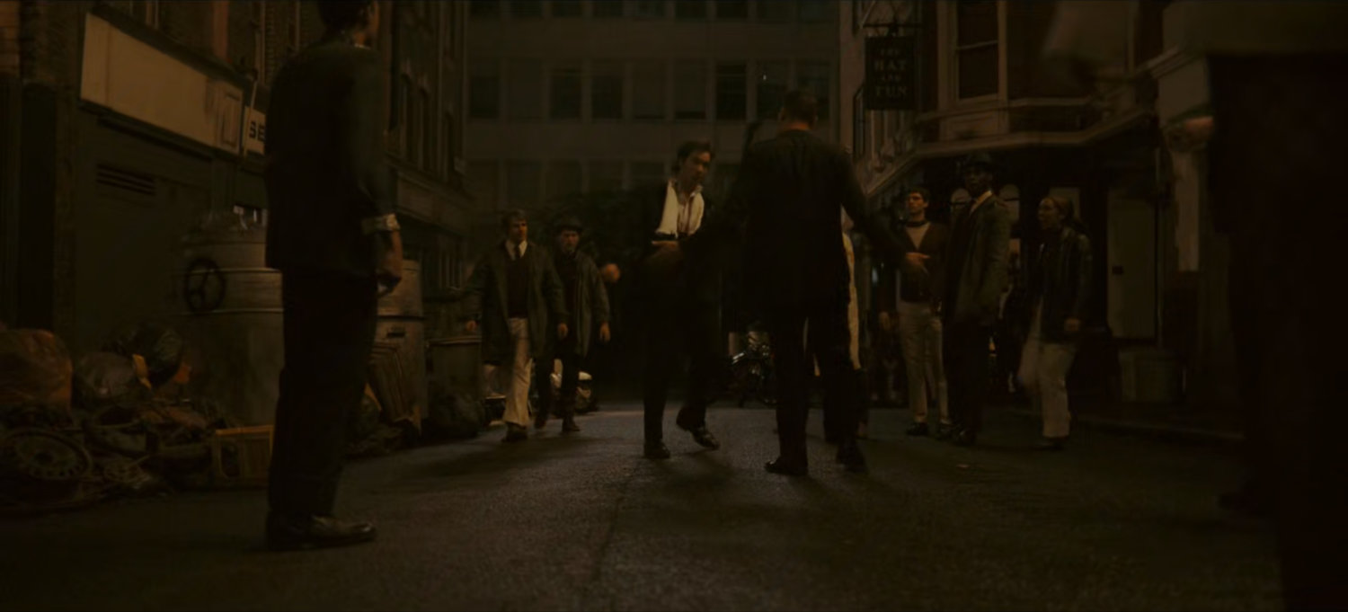 Brad confronted by citizens on dark London street.