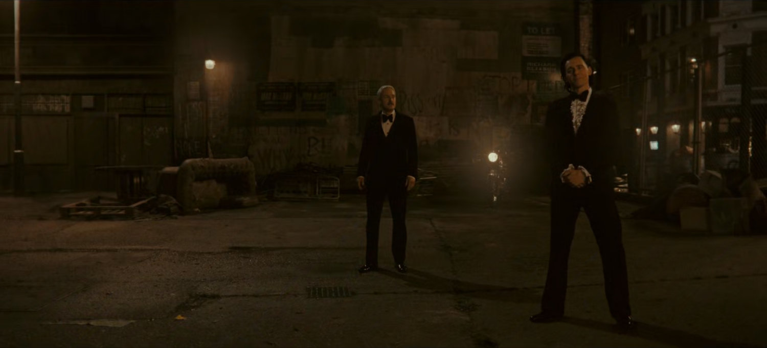 Loki and Mobius in dark abandoned lot.