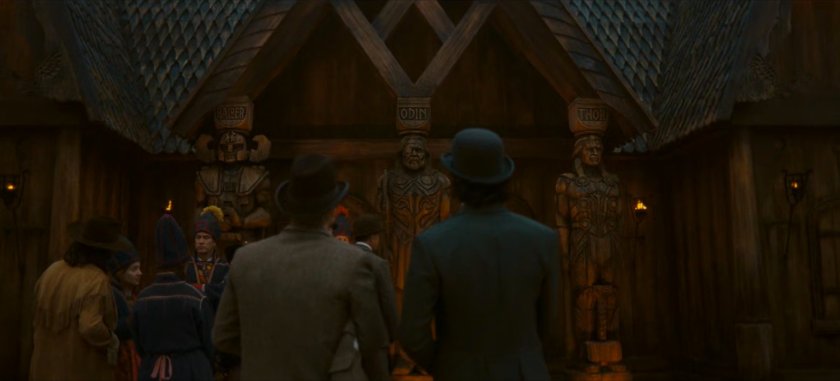 Loki and Mobius on the Chicago Fair midway in front of statues of Balder, Odin, and Thor..