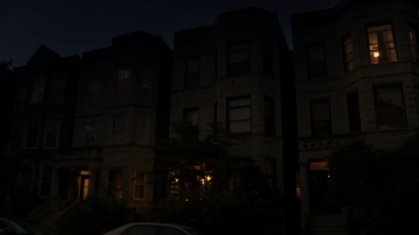 Exterior of row home at night.