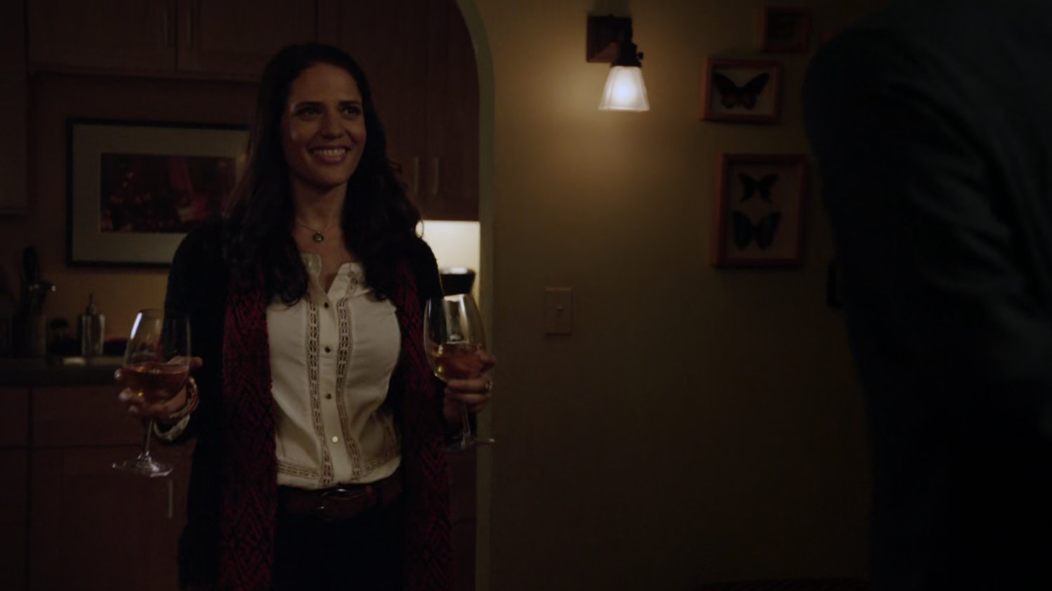 Janice Robbins holding two glasses of wine.