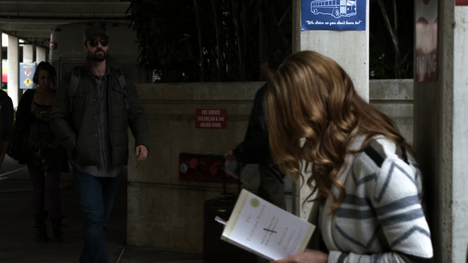 Grant Ward walking past Bobbi at a bus terminal.