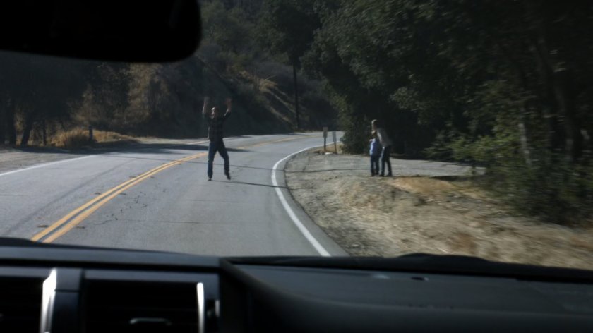 Hank Thompson flags down a vehicle on a rural road outside his house.