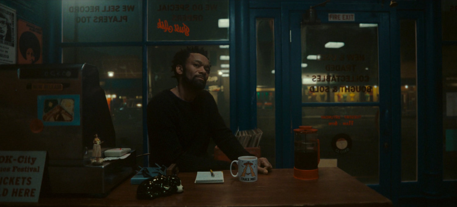Man behind counter at Broxton record store.