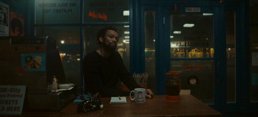 Man behind counter at Broxton record store.