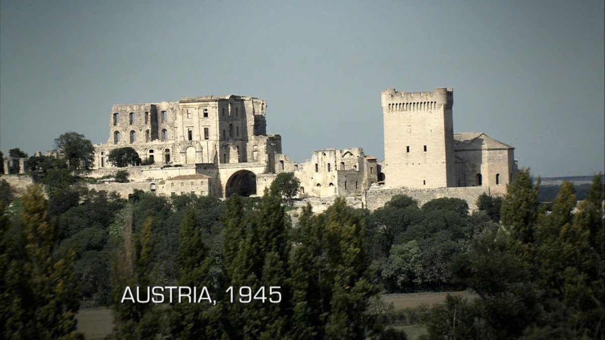 Aerial of old castle. Text: Austria, 1945.