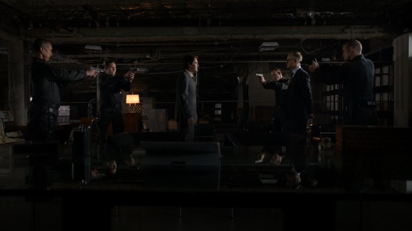 Men draw guns on Calvin Zabo inside a HYDRA warehouse/bunker.