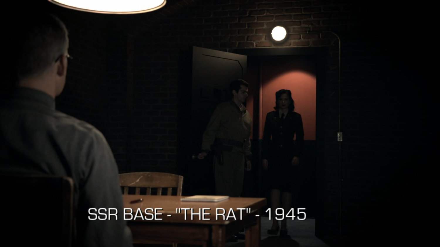 Peggy Carter enters a brick room. Text: SSR Base - "The Rat" - 1945.