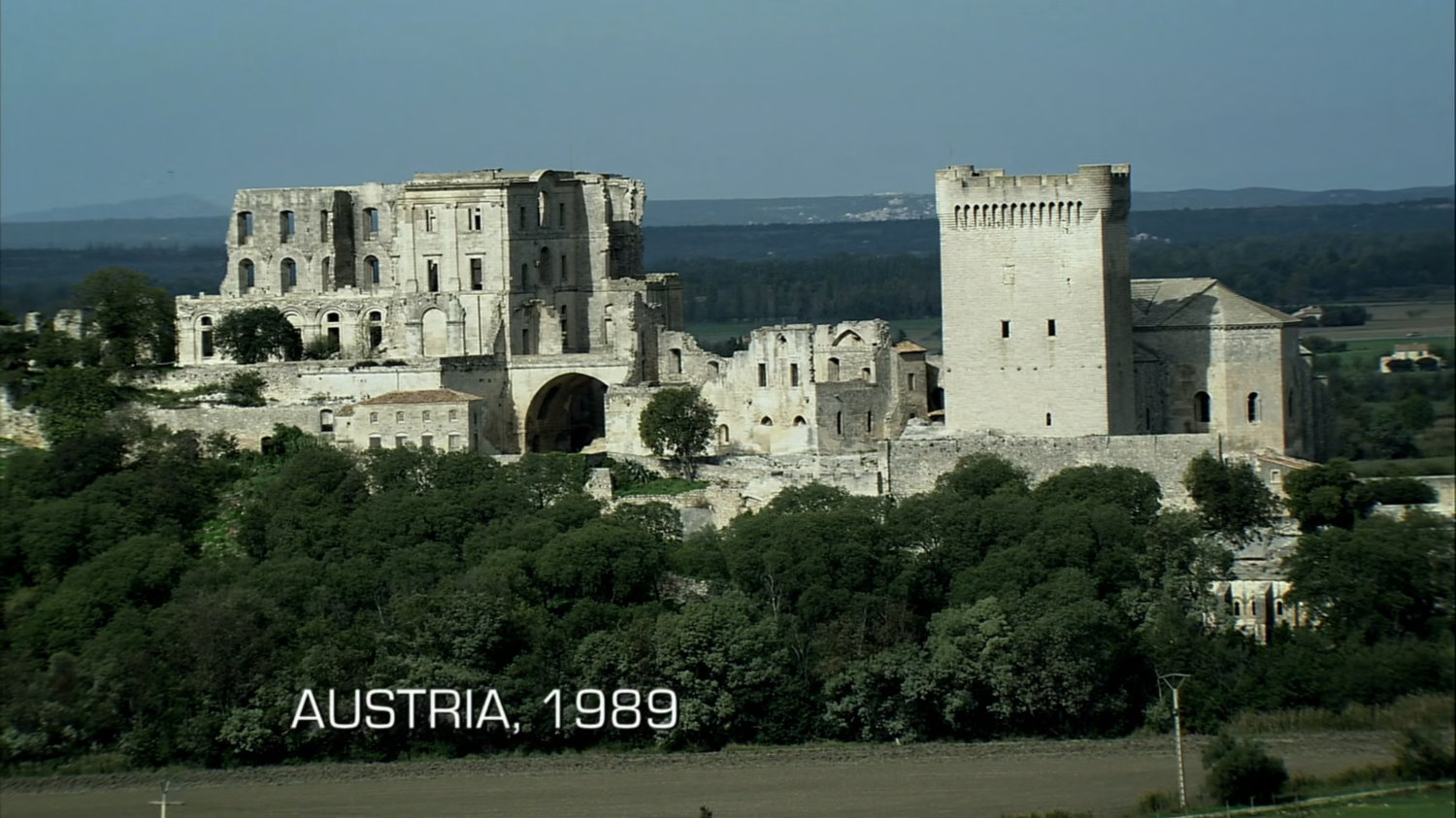 Aerial of old castle. Text: Austria, 1989.