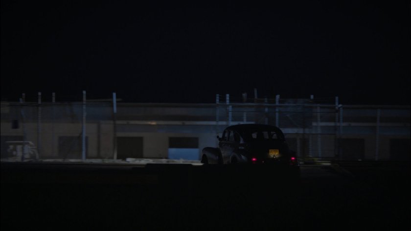Car drives into warehouse area.