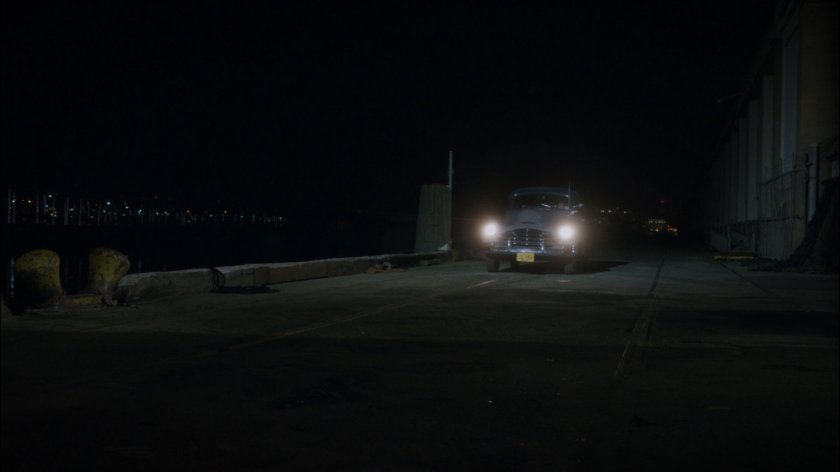 Car pulling up along wharf.