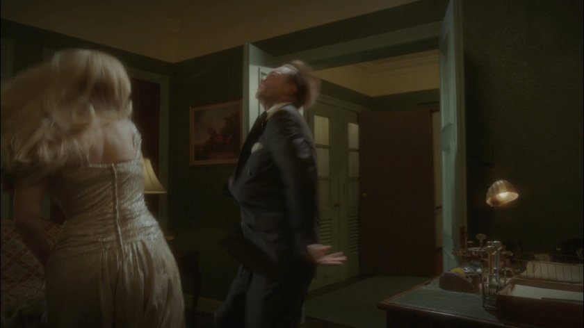 Peggy knocks out thug in Spider Raymond's office.