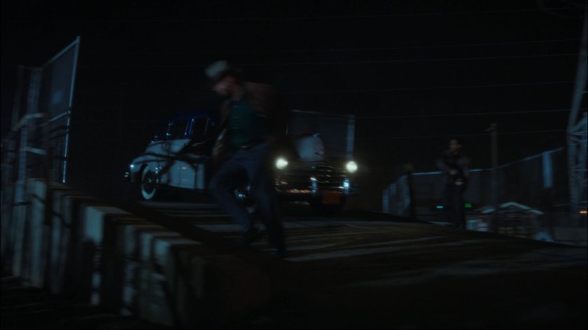 Car drives over bridge at Roxxon refinery.