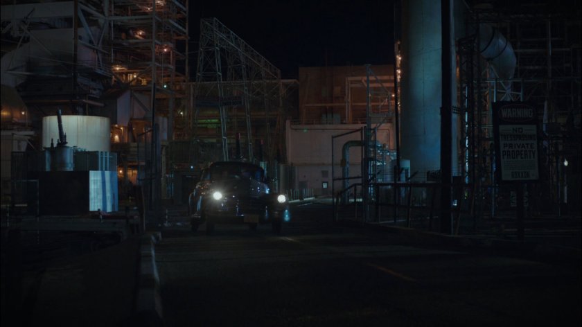 Car drives away from Roxxon refinery.