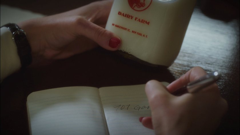 Closeup Daisy Clover milk bottle and address.