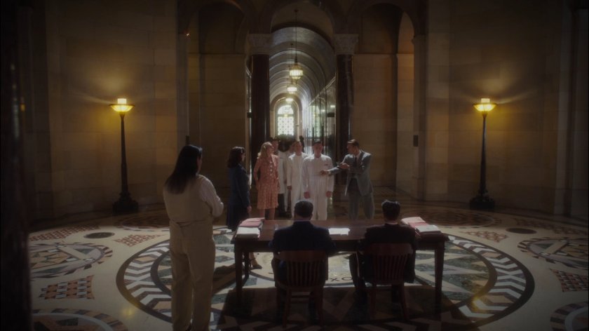 Employees line up in Roxxon lobby for inspection.