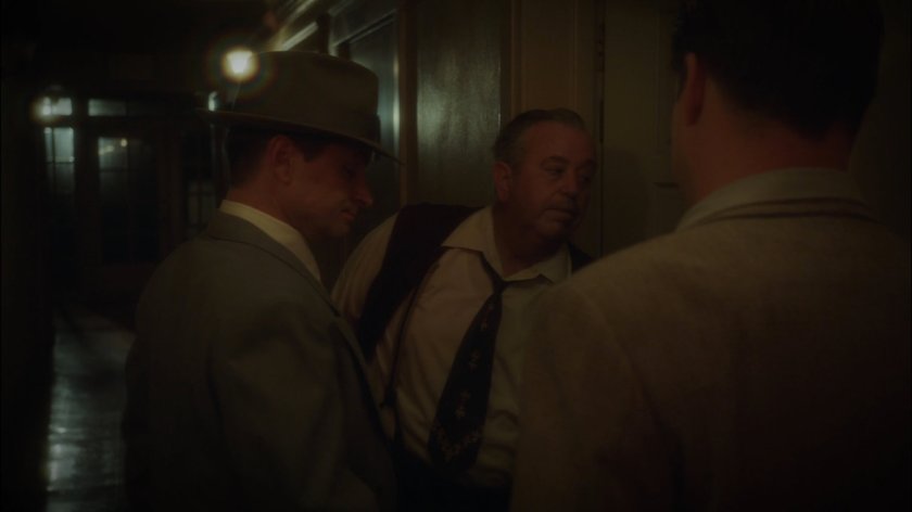 Landlord, Dooley and Krzeminski in hallway of Hotel Cosmopole.