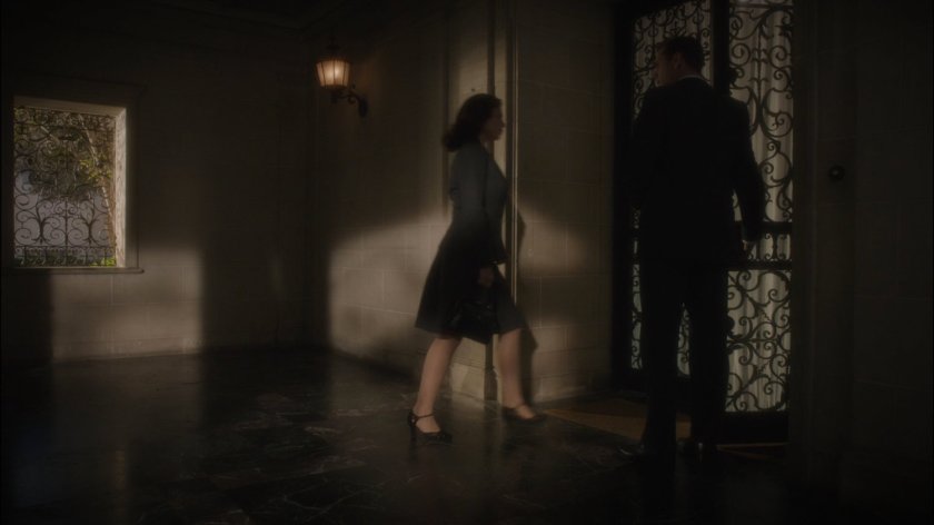 Jarvis holds the door for Peggy at Howard Stark's mansion.