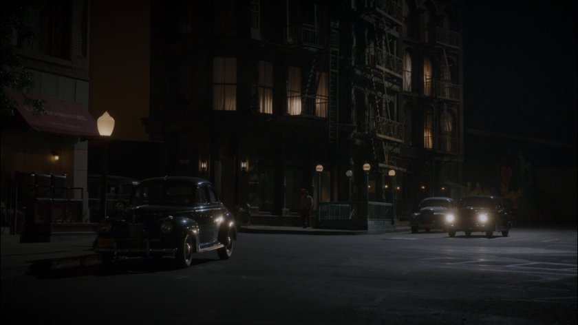 Car on dark New York city street.