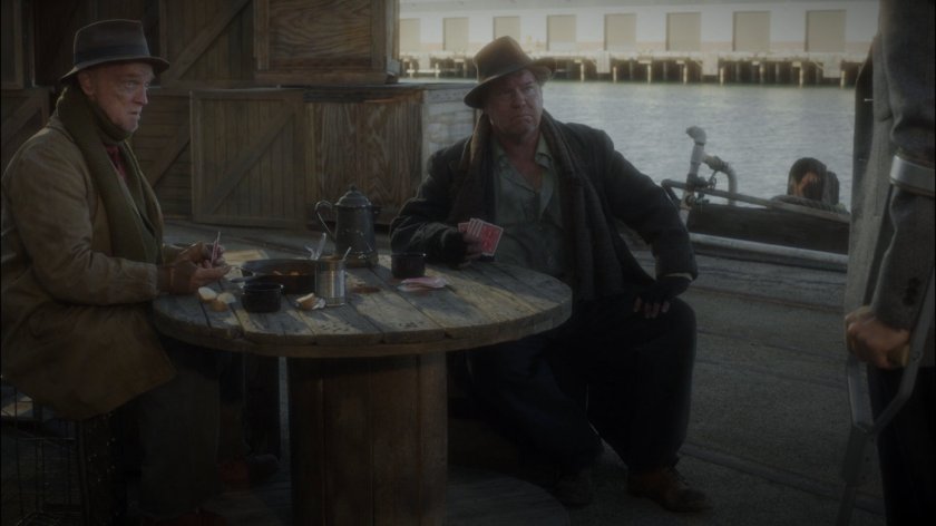 Two hobo's play cards on Dock 12.