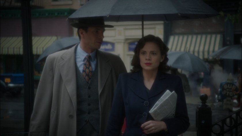 Peggy and Jarvis on a rainy New York sidewalk.