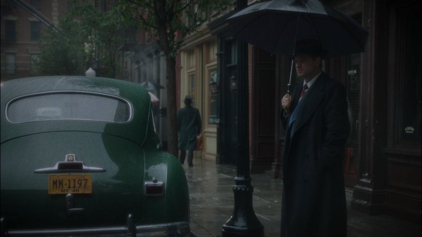 Chief Dooley stands on a rainy new York sidewalk.