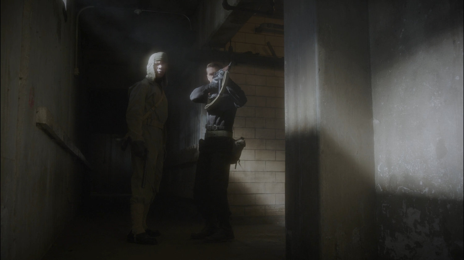 Thompson takes aim down a hallway of Belarus prison.