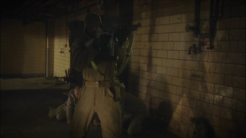 Happy Sam Sawyer firing rifle in Belarus prison.