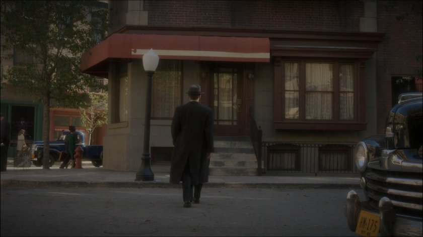 Agent Yauch crossing street outside Filth's Pub.