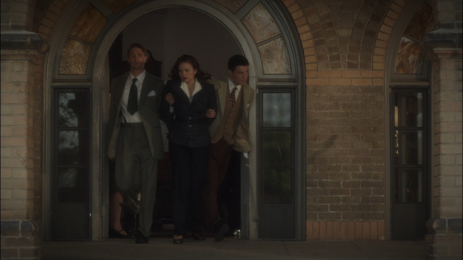 Thompson and Sousa escort Peggy out of The Griffith Hotel.