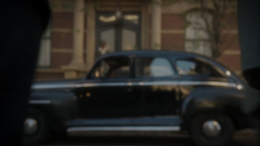 A car parked across the street from the Griffith Hotel.