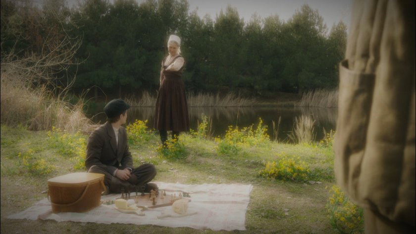 A young soldier and his mother by a lake.