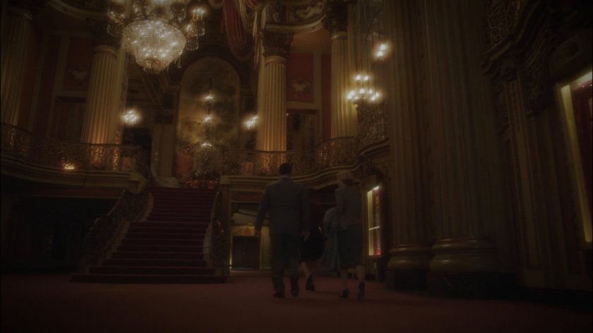 Patrons in movie theater lobby.