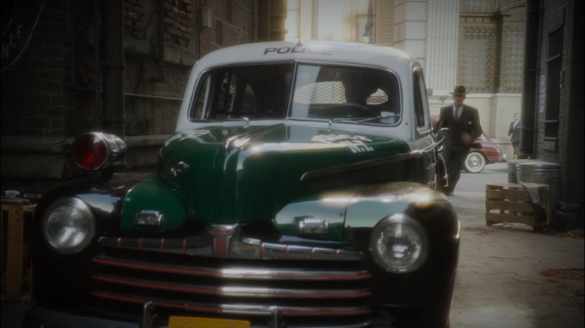 Jarvis runs into alley to see a police car pulling away.