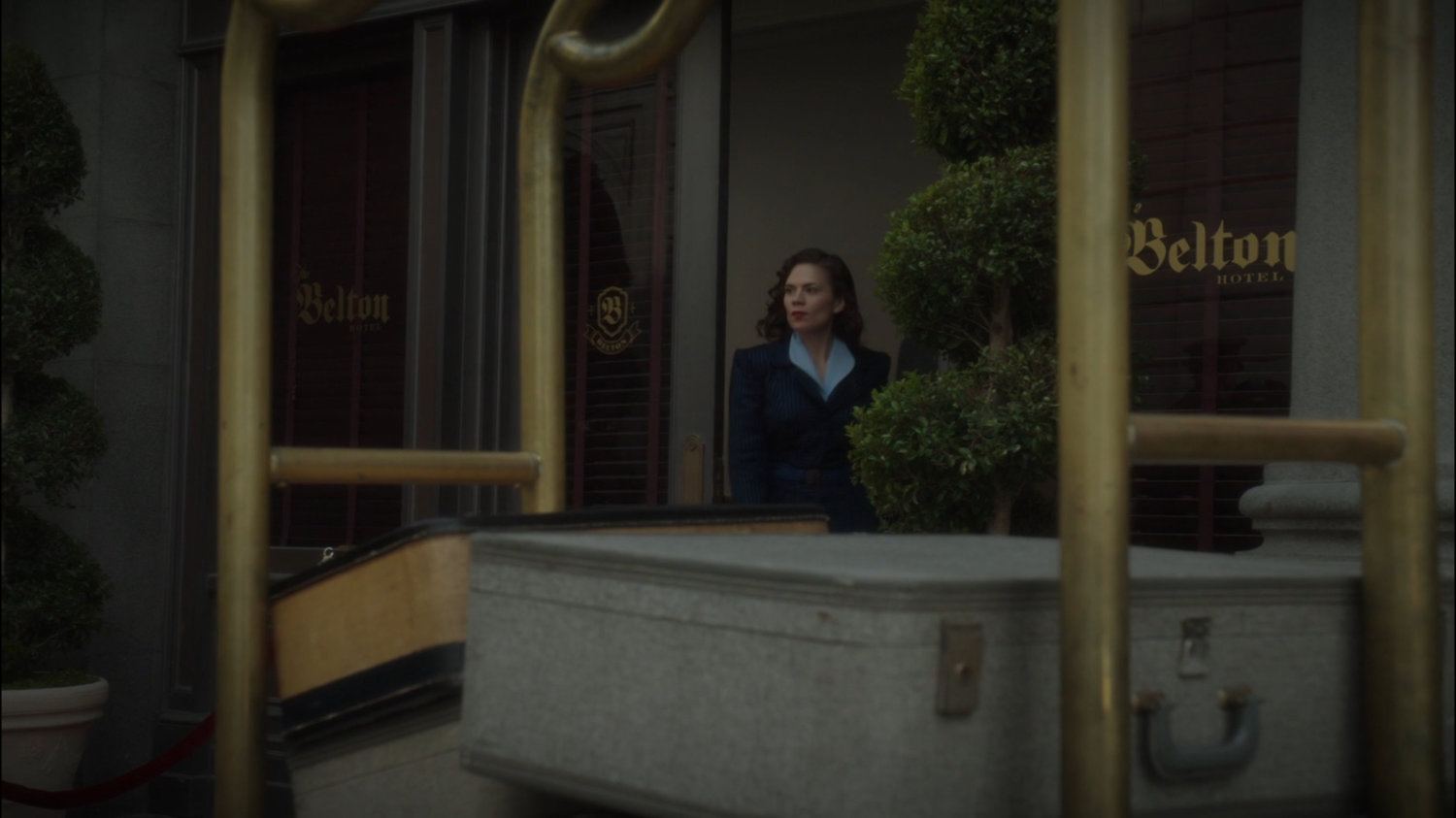 Peggy exits the Belton Hotel.