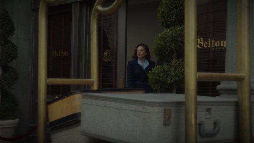 Peggy exits the Belton Hotel.