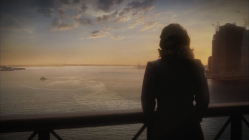 Peggy stands on the Brooklyn Bridge.