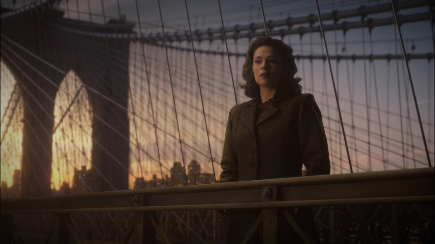 Peggy stands on the Brooklyn Bridge.