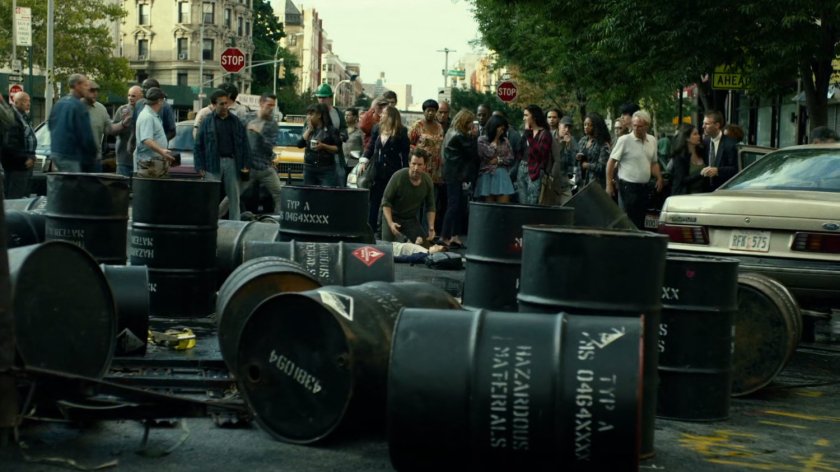 Hazardous chemical barrels strewn across New York intersection.
