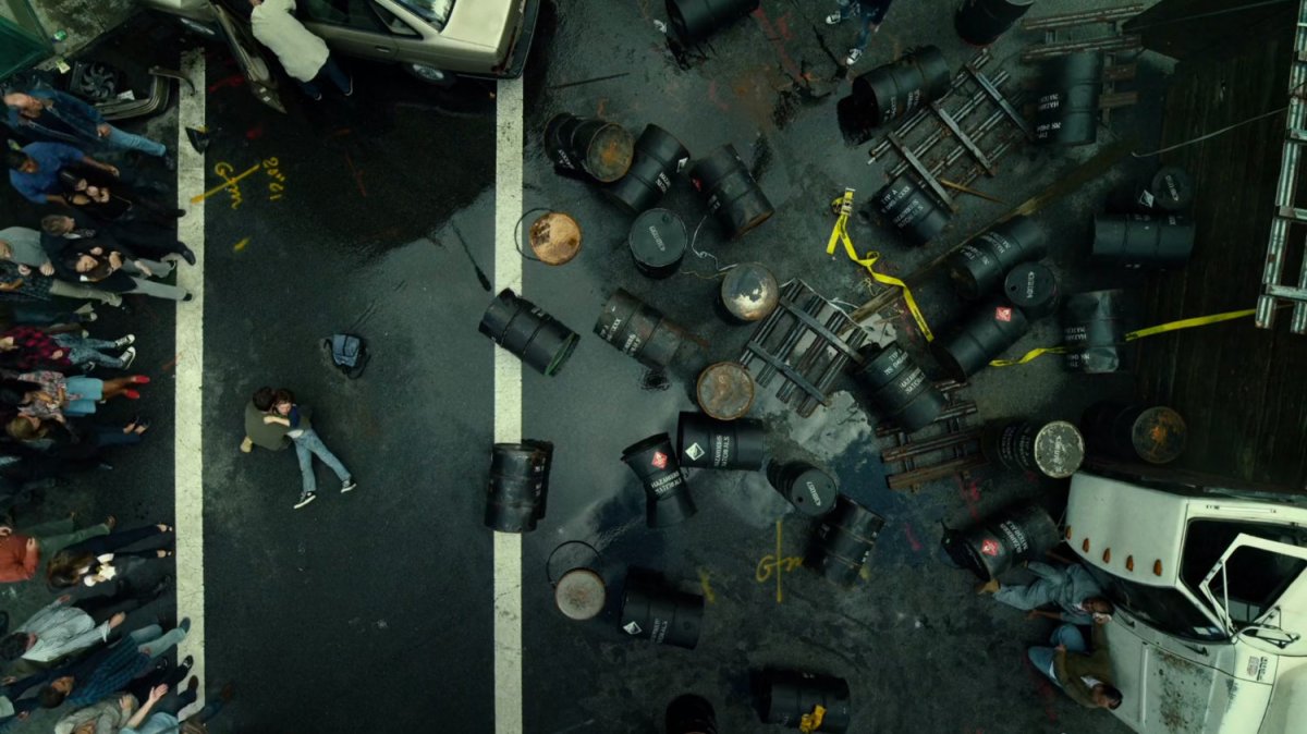 Aerial view of hazardous chemical barrels strewn across New York intersection.