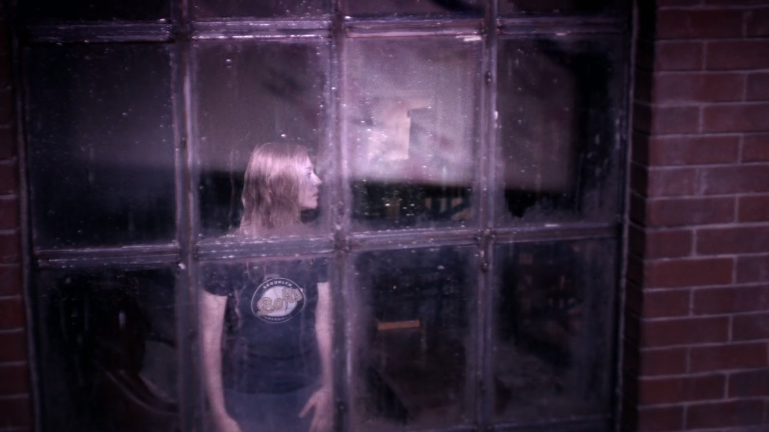 Karen in window of Matt's apartment.
