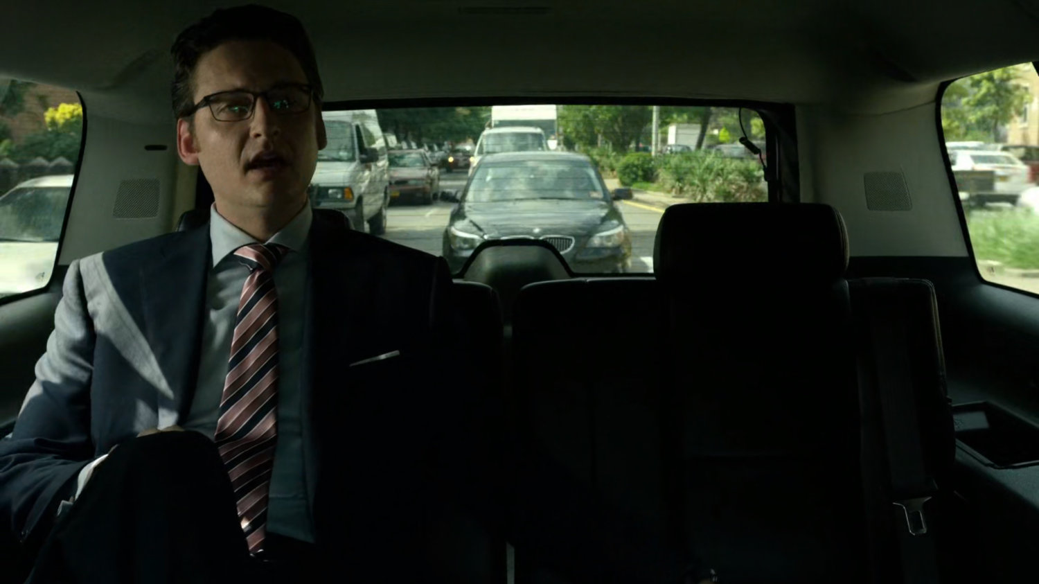Wesley in car driving on New York street.
