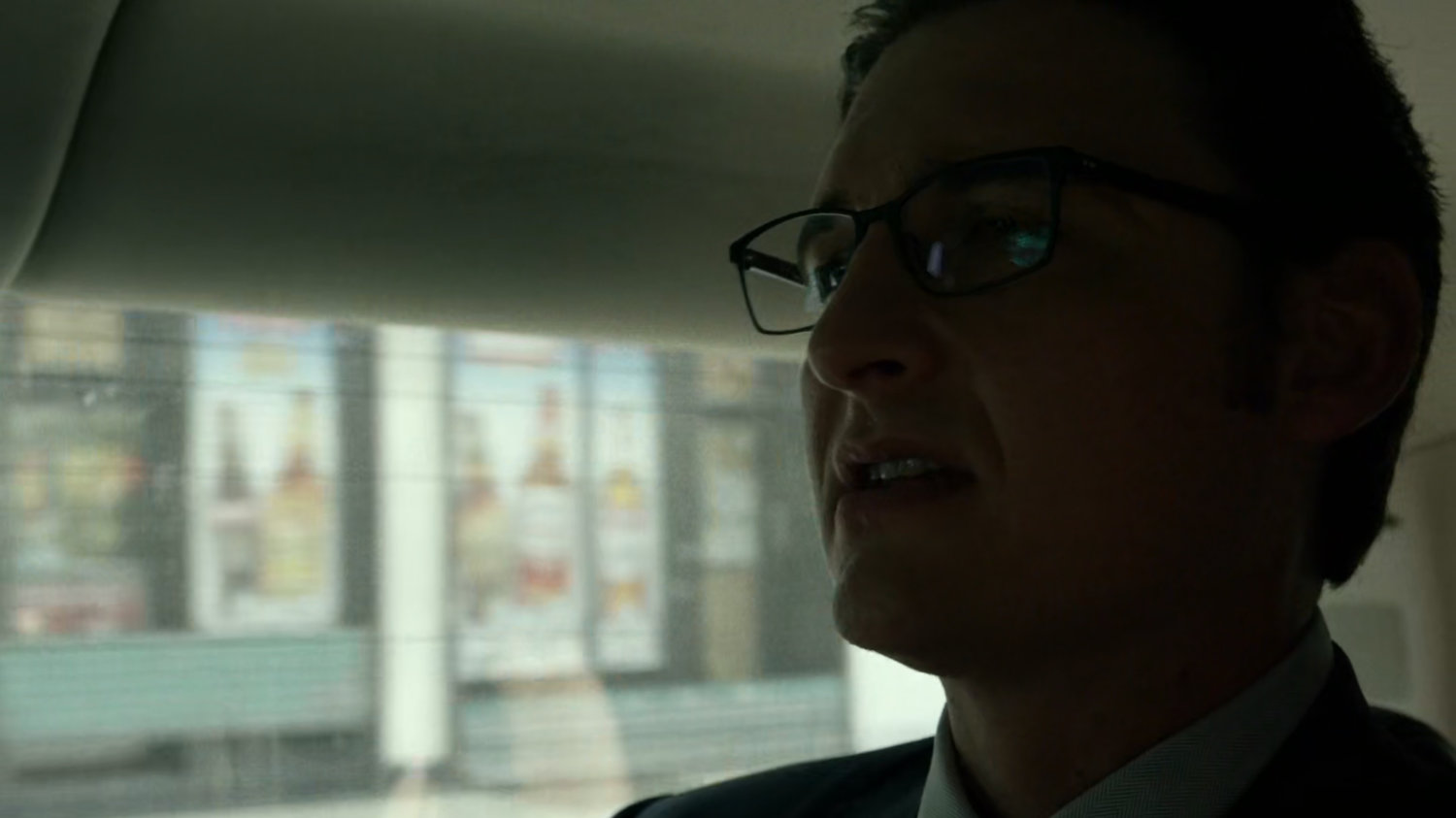 Wesley in car driving on New York street.