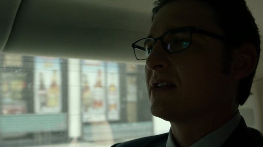 Wesley in car driving on New York street.